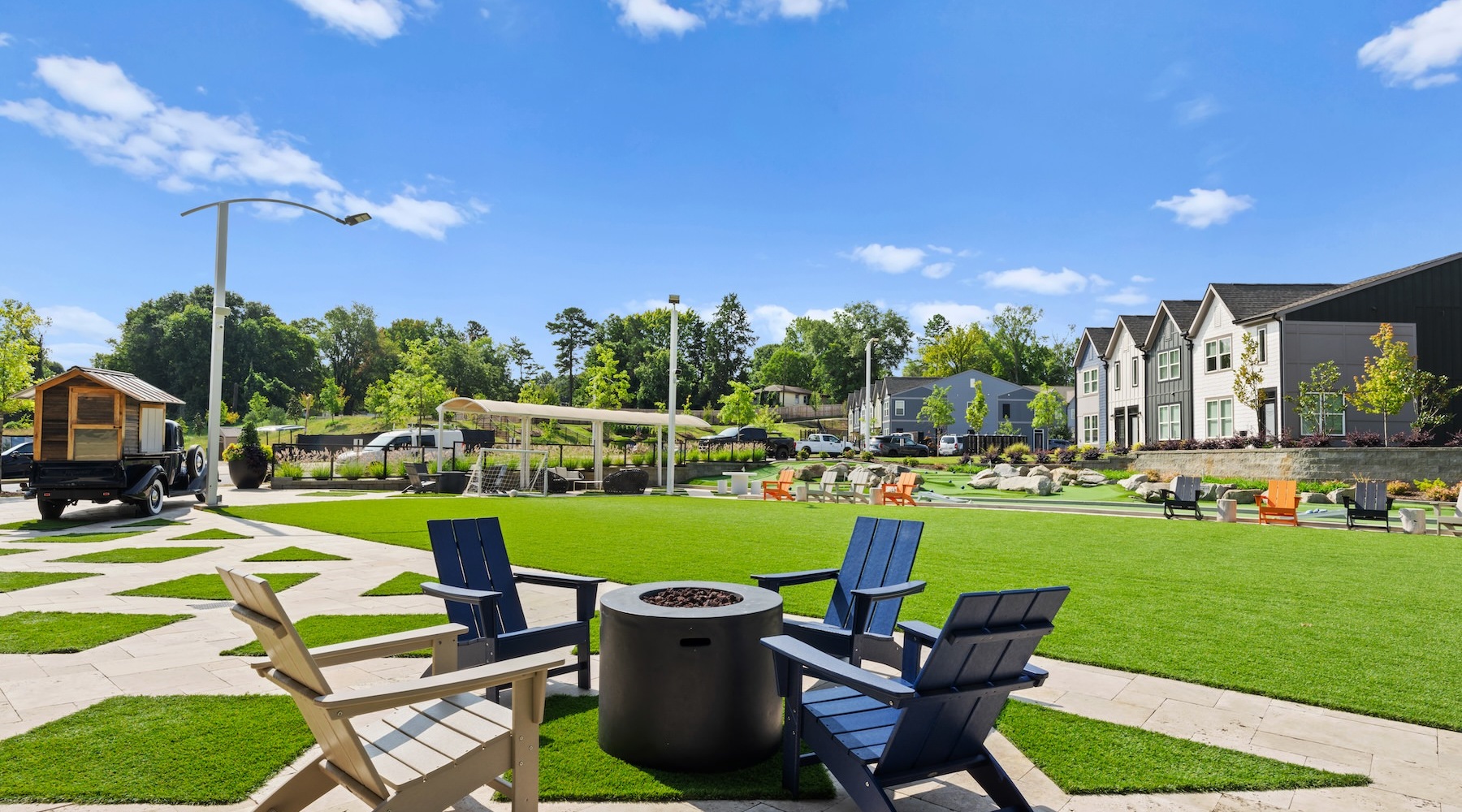 Beautiful turf flex field with seating around fire pit at Blu South homes for rent in Pineville Beautiful turf flex field with seating around fire pit at Blu South homes for rent in Pineville