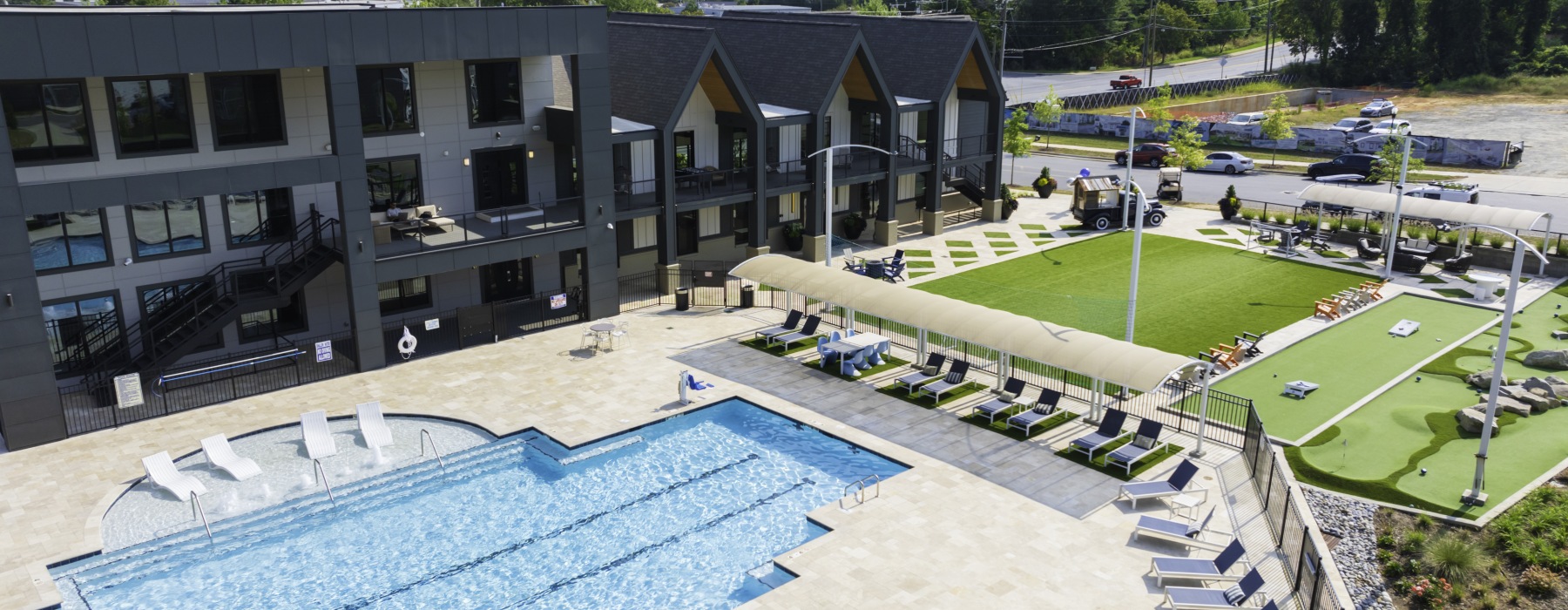 Pool and turf flex fields with 9-hole mini-putt course at Blu South luxury apartment townhomes in Pineville, NC